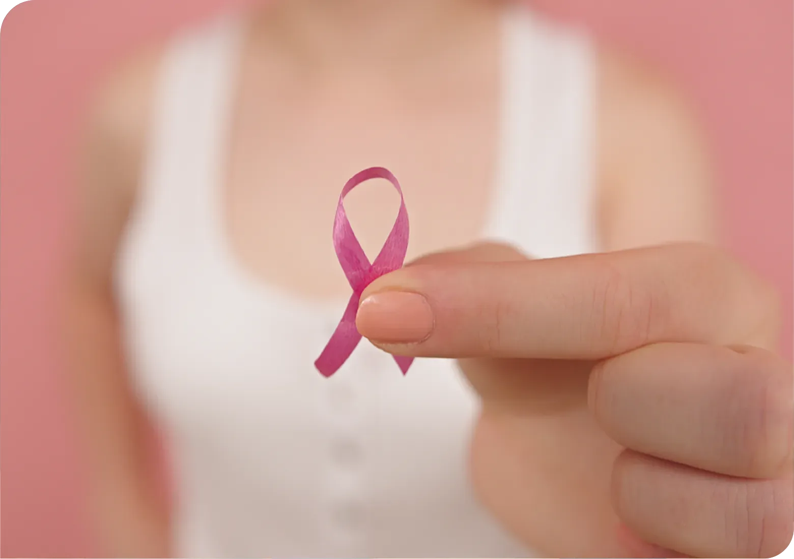 An image of a woman holding a breast cancer awareness ribbon.